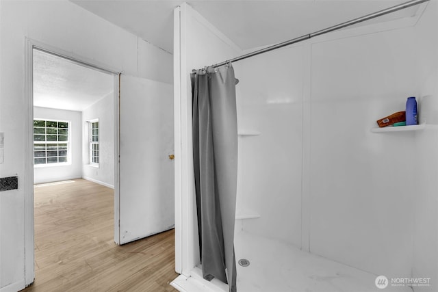 241B Foster Creek Rd, Toledo, WA 98591 - full bathroom with wood finished floors and a shower with shower curtain