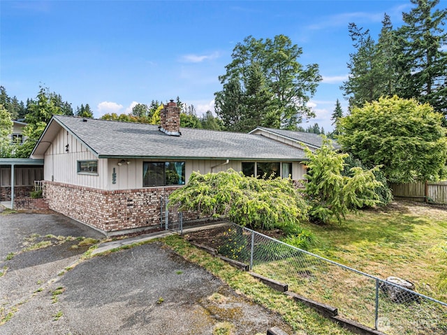 152 E Park Ln, Port Angeles, WA 98362 - ranch-style home featuring a chimney, a shingled roof, brick siding, and board and batten siding