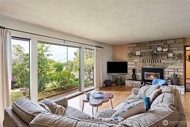 152 E Park Ln, Port Angeles, WA 98362 - living room with a textured ceiling, wood finished floors, and a fireplace