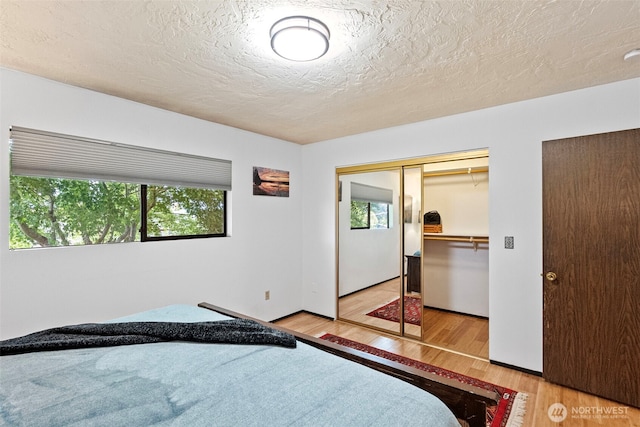 152 E Park Ln, Port Angeles, WA 98362 - bedroom with wood finished floors, a textured ceiling, and a closet