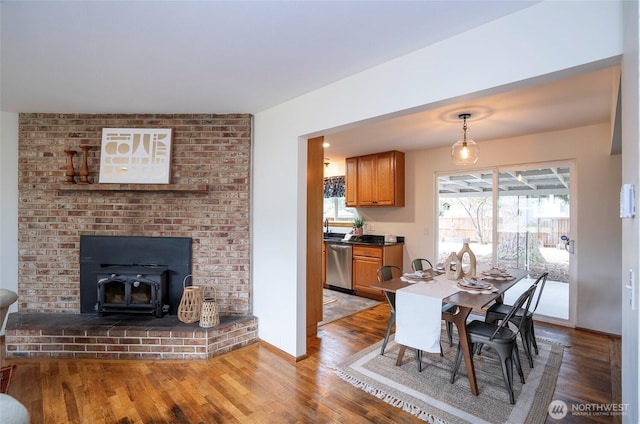 8618 94th St SW, Lakewood, WA 98498 - dining space featuring a wood stove and light wood-type flooring