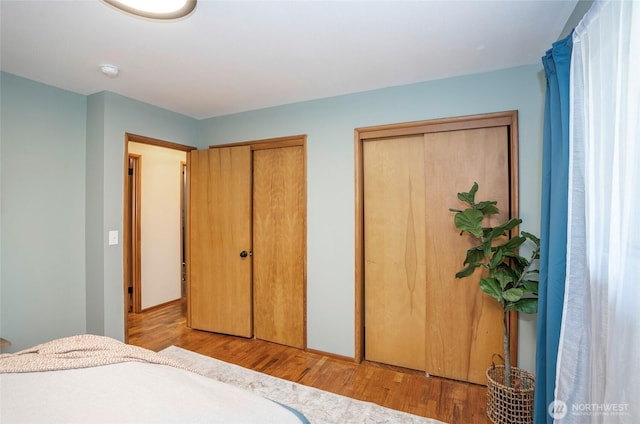 8618 94th St SW, Lakewood, WA 98498 - bedroom with multiple closets and wood finished floors