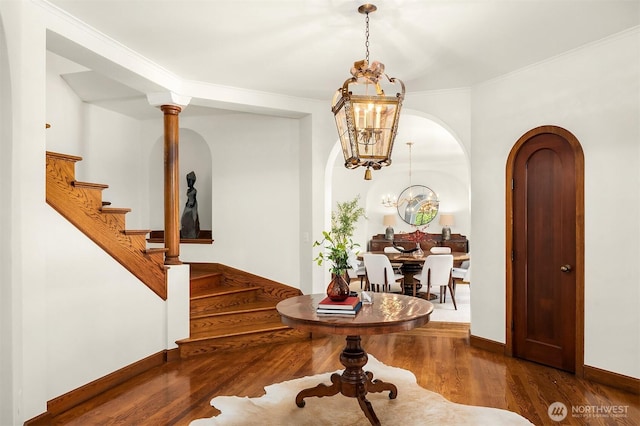 3103 Mount Rainier Dr S, Seattle, WA 98144 - foyer entrance with stairs, arched walkways, a chandelier, wood finished floors, and crown molding