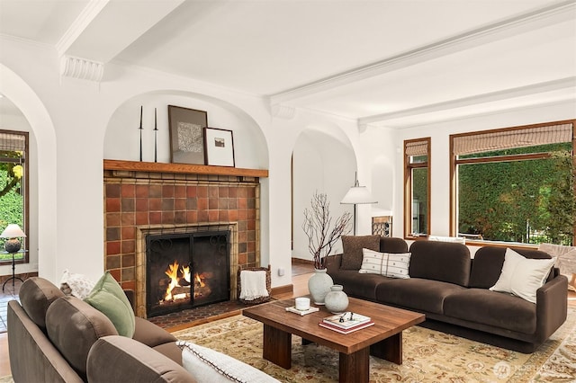 3103 Mount Rainier Dr S, Seattle, WA 98144 - living area with a fireplace, beamed ceiling, wood finished floors, arched walkways, and crown molding