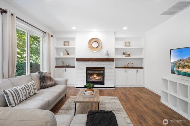 9220 NE 195th St, Bothell, WA 98011 - living area featuring built in features, dark wood finished floors, a brick fireplace, and recessed lighting