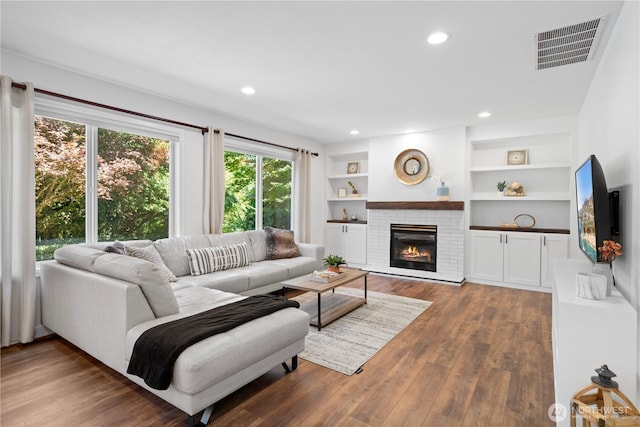 9220 NE 195th St, Bothell, WA 98011 - living area with a fireplace, wood finished floors, recessed lighting, and built in shelves