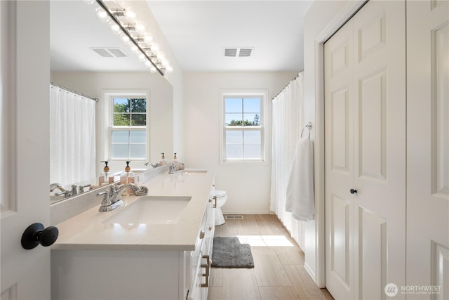 9220 NE 195th St, Bothell, WA 98011 - bathroom featuring double vanity and wood finished floors