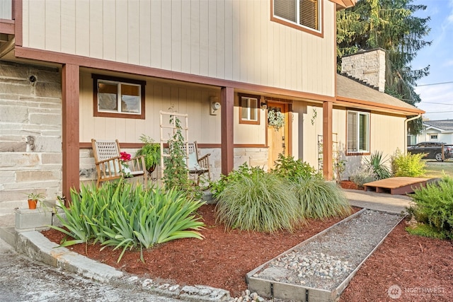 407 Leber St NE, Orting, WA 98360 - doorway to property featuring a chimney and a porch