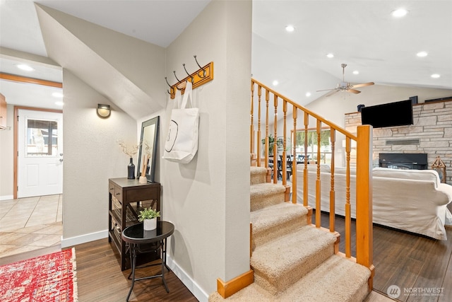 407 Leber St NE, Orting, WA 98360 - staircase featuring a ceiling fan, recessed lighting, vaulted ceiling, wood finished floors, and a fireplace