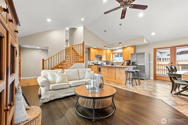 407 Leber St NE, Orting, WA 98360 - living room with vaulted ceiling, ceiling fan, stairs, light wood-style flooring, and recessed lighting