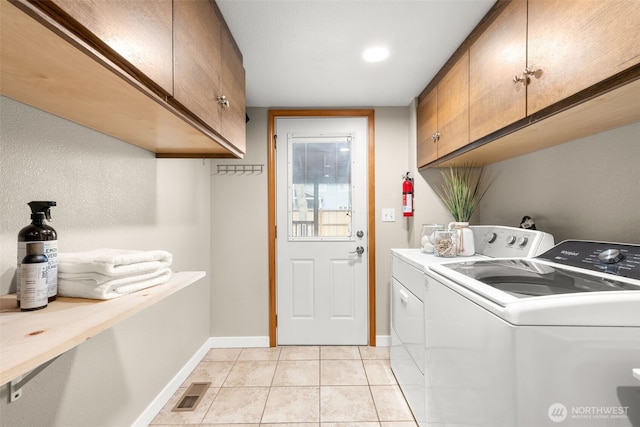 407 Leber St NE, Orting, WA 98360 - laundry room with cabinet space, washer and dryer, and light tile patterned floors