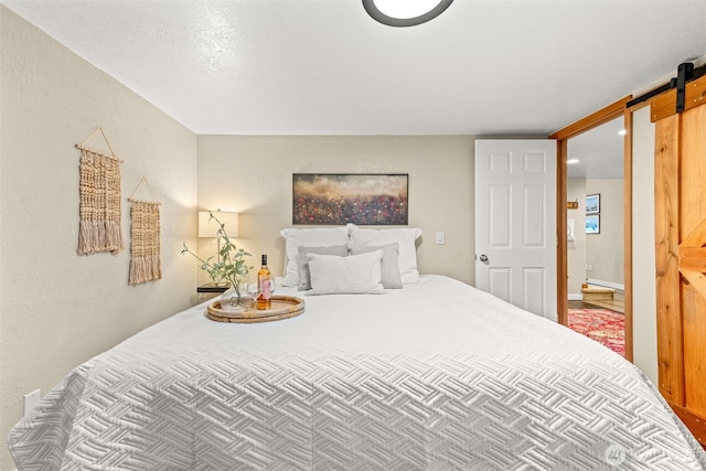 407 Leber St NE, Orting, WA 98360 - bedroom with a barn door and a textured wall