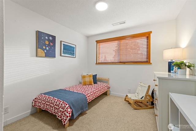 407 Leber St NE, Orting, WA 98360 - carpeted bedroom with a textured ceiling and baseboards