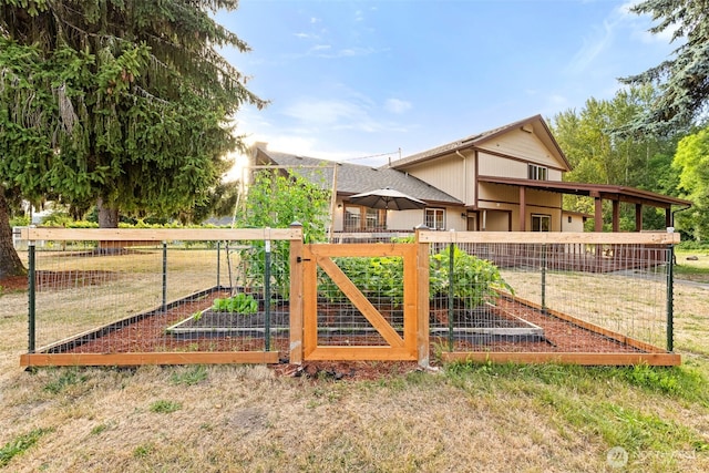407 Leber St NE, Orting, WA 98360 - view of yard with a vegetable garden and a gate