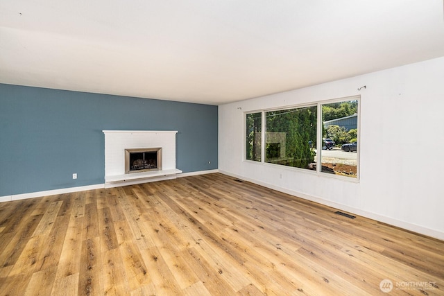 6808 NE 165th St, Kenmore, WA 98028 - unfurnished living room with wood finished floors and a brick fireplace