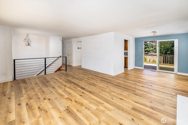 6808 NE 165th St, Kenmore, WA 98028 - empty room featuring a chandelier and light wood-type flooring
