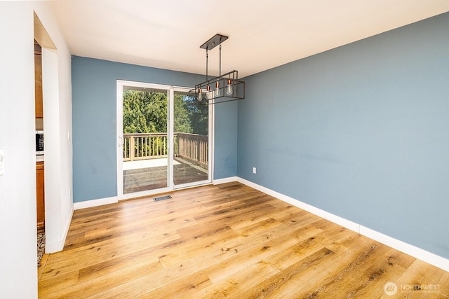 6808 NE 165th St, Kenmore, WA 98028 - unfurnished dining area with a chandelier and light wood-style flooring