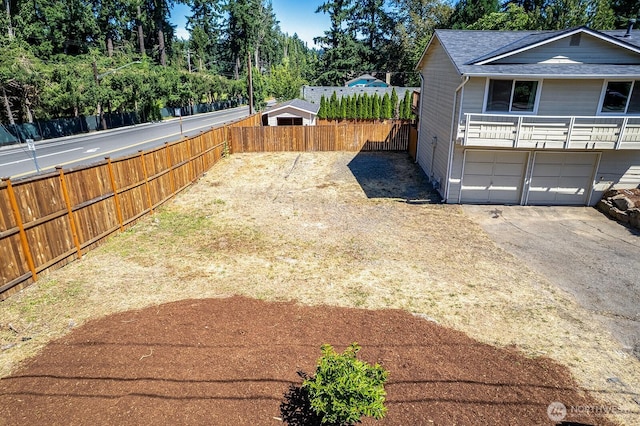 6808 NE 165th St, Kenmore, WA 98028 - view of yard featuring driveway, a garage, and view of wooded area