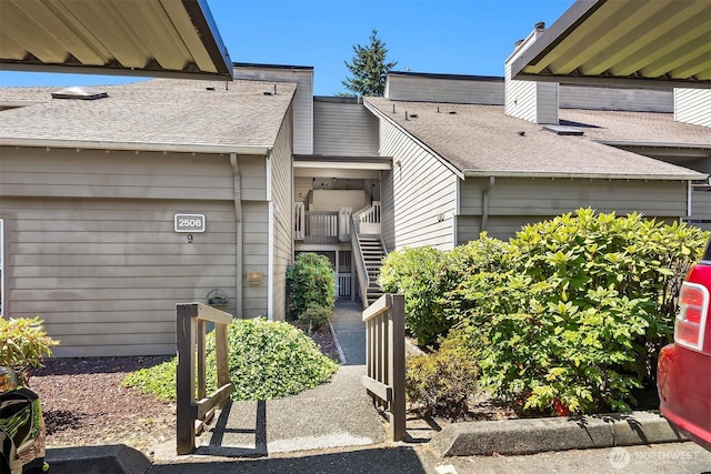 2506 S 317th St Unit 103, Federal Way, WA 98003 - view of exterior entry featuring a shingled roof