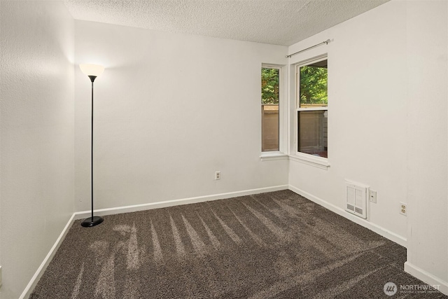 2506 S 317th St Unit 103, Federal Way, WA 98003 - unfurnished room with dark colored carpet and a textured ceiling