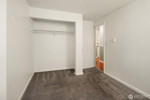 2506 S 317th St Unit 103, Federal Way, WA 98003 - unfurnished bedroom with carpet, a textured ceiling, and a closet