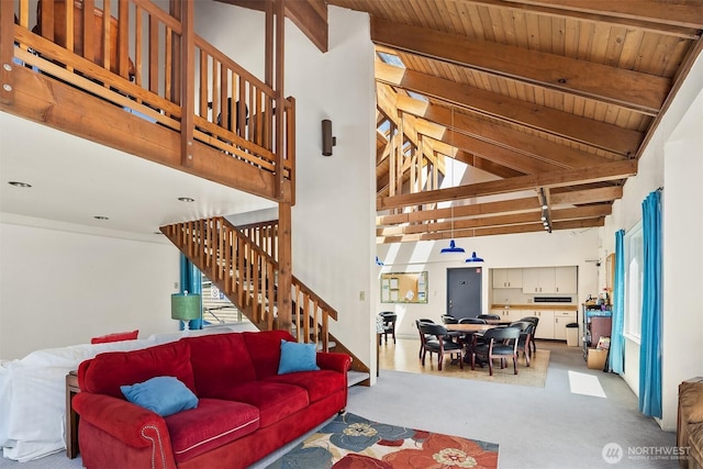 2506 S 317th St Unit 103, Federal Way, WA 98003 - living room with high vaulted ceiling, carpet flooring, stairway, and a wooden ceiling with exposed beams