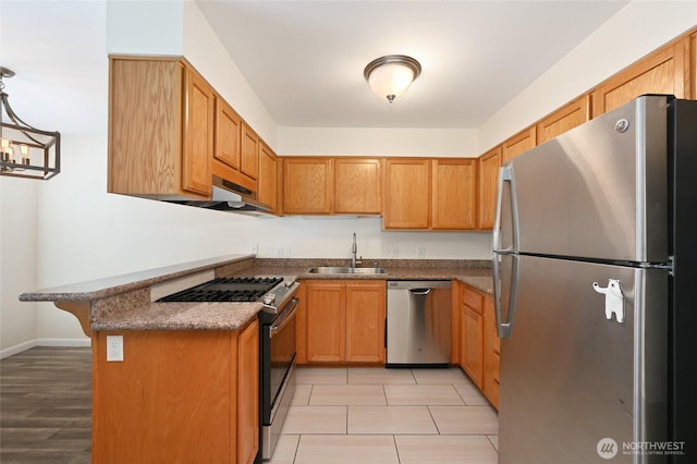 1255 NE 152nd St Unit 3, Shoreline, WA 98155 - kitchen featuring stainless steel appliances, a breakfast bar area, a peninsula, and brown cabinetry
