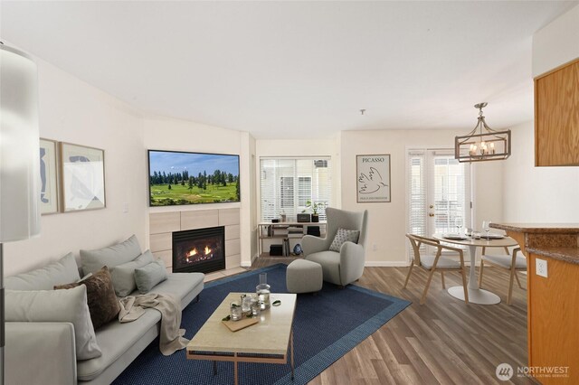 1255 NE 152nd St Unit 3, Shoreline, WA 98155 - living room featuring a fireplace, wood finished floors, and a chandelier
