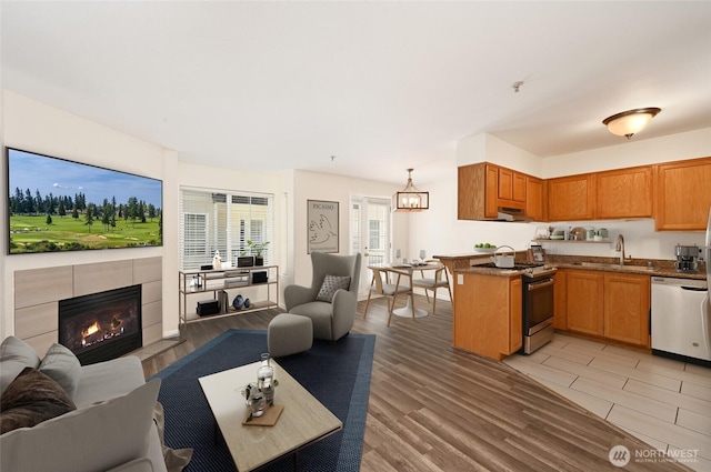 1255 NE 152nd St Unit 3, Shoreline, WA 98155 - living area with light wood finished floors and a tiled fireplace
