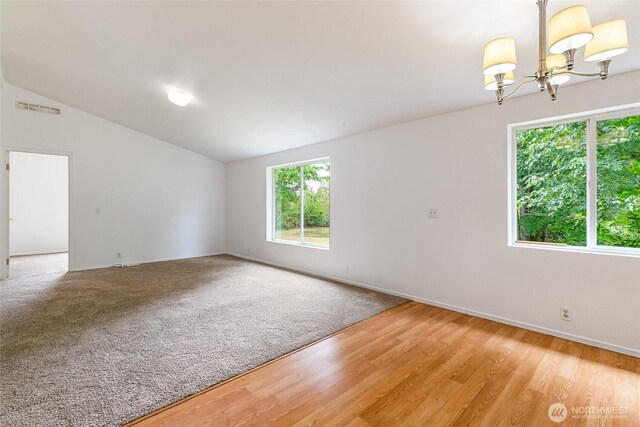 370 Van Wyck Rd, Bellingham, WA 98226 - spare room featuring a chandelier, lofted ceiling, and light wood-type flooring