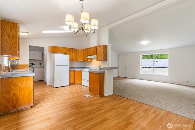 370 Van Wyck Rd, Bellingham, WA 98226 - kitchen featuring white appliances, open floor plan, under cabinet range hood, a chandelier, and brown cabinetry
