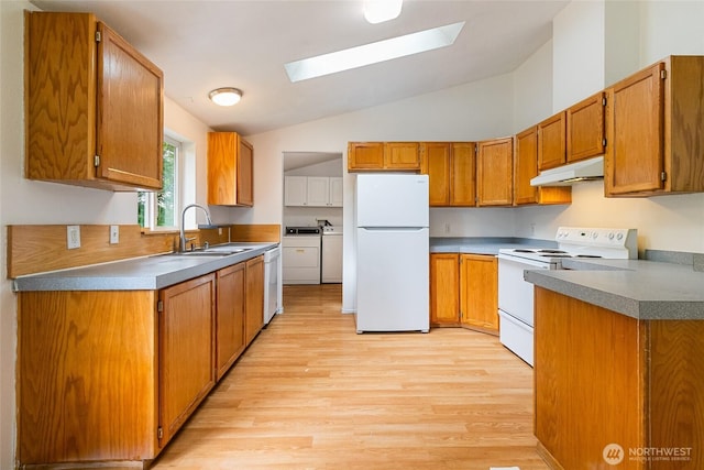 370 Van Wyck Rd, Bellingham, WA 98226 - kitchen featuring white appliances, under cabinet range hood, washing machine and dryer, a skylight, and light wood-type flooring