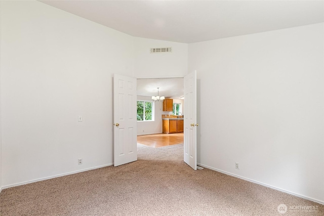 370 Van Wyck Rd, Bellingham, WA 98226 - empty room with light colored carpet, a chandelier, and lofted ceiling