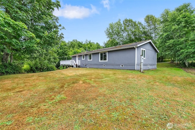 370 Van Wyck Rd, Bellingham, WA 98226 - back of property featuring crawl space, a yard, a deck, and view of wooded area