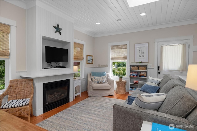17 Beach Cabin Ln, Pacific Beach, WA 98571 - living area with crown molding, healthy amount of natural light, wood finished floors, a glass covered fireplace, and wooden ceiling