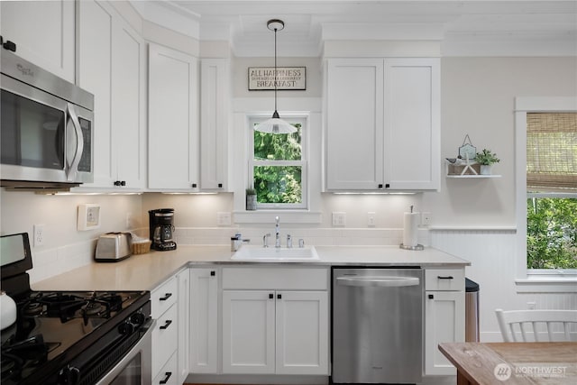 17 Beach Cabin Ln, Pacific Beach, WA 98571 - kitchen with stainless steel appliances, white cabinetry, light countertops, and pendant lighting