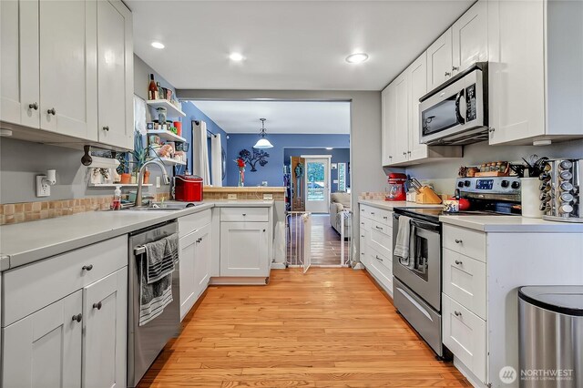 14812 SE 368th Pl, Auburn, WA 98092 - kitchen with stainless steel appliances, white cabinetry, light countertops, light wood-style floors, and recessed lighting