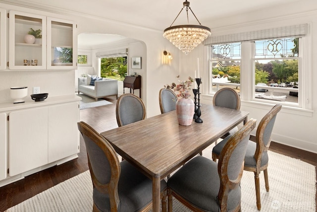 3106 NE 60th St, Seattle, WA 98115 - dining area with arched walkways, dark wood-type flooring, a chandelier, and crown molding