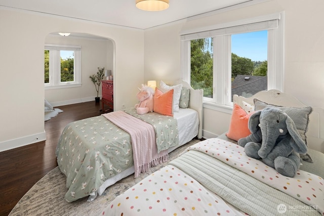 3106 NE 60th St, Seattle, WA 98115 - bedroom featuring arched walkways, multiple windows, and wood finished floors