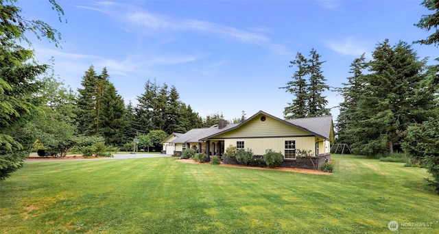 599 Loomis Trail Rd, Lynden, WA 98264 - back of house with an attached garage, a yard, and a chimney