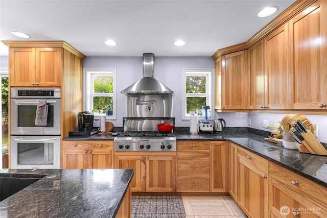 599 Loomis Trail Rd, Lynden, WA 98264 - kitchen with appliances with stainless steel finishes, wall chimney range hood, dark stone counters, recessed lighting, and brown cabinetry