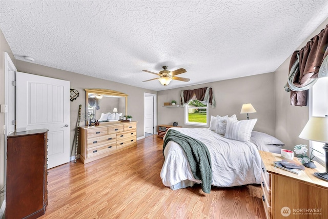 599 Loomis Trail Rd, Lynden, WA 98264 - bedroom featuring light wood-type flooring, a textured ceiling, and a ceiling fan