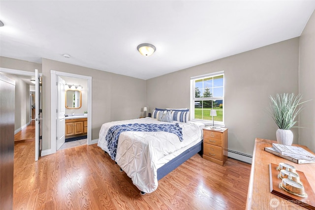 599 Loomis Trail Rd, Lynden, WA 98264 - bedroom featuring baseboard heating, light wood-style flooring, and ensuite bath
