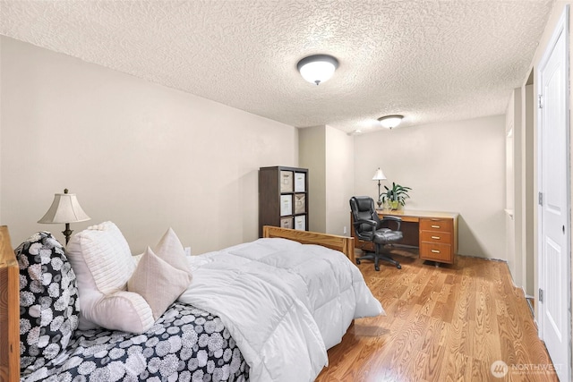 599 Loomis Trail Rd, Lynden, WA 98264 - bedroom with light wood-style floors, a textured ceiling, and an office area