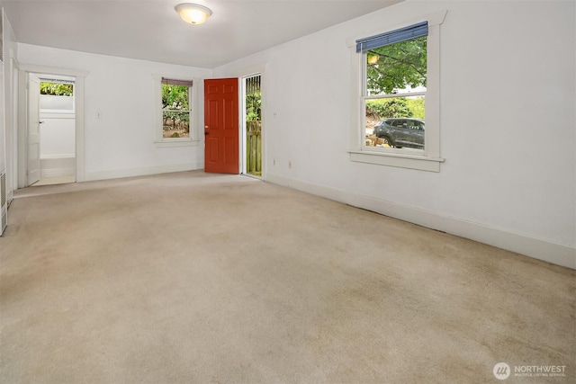 9559 College Way N, Seattle, WA 98103 - empty room with plenty of natural light and carpet flooring