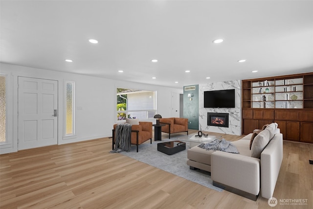 13511 SE 266th St, Kent, WA 98042 - living room featuring a fireplace, light wood-style flooring, and recessed lighting