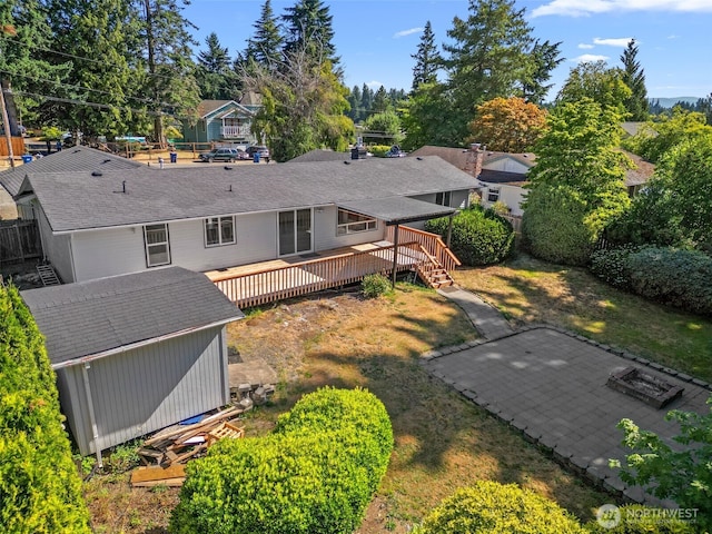 13511 SE 266th St, Kent, WA 98042 - back of property featuring a deck, a storage shed, and a shingled roof
