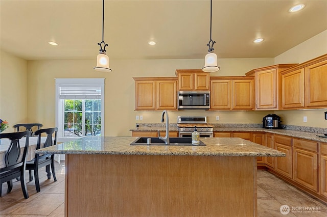 218 Lilly Ln, Mount Vernon, WA 98274 - kitchen with stainless steel appliances, recessed lighting, light tile patterned flooring, light stone counters, and hanging light fixtures