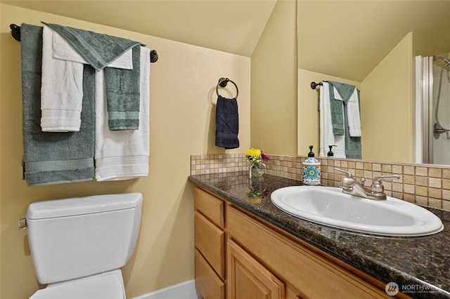 218 Lilly Ln, Mount Vernon, WA 98274 - bathroom featuring vanity, backsplash, and lofted ceiling