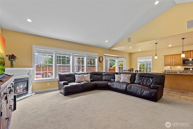 218 Lilly Ln, Mount Vernon, WA 98274 - living area featuring vaulted ceiling, light colored carpet, recessed lighting, and a glass covered fireplace